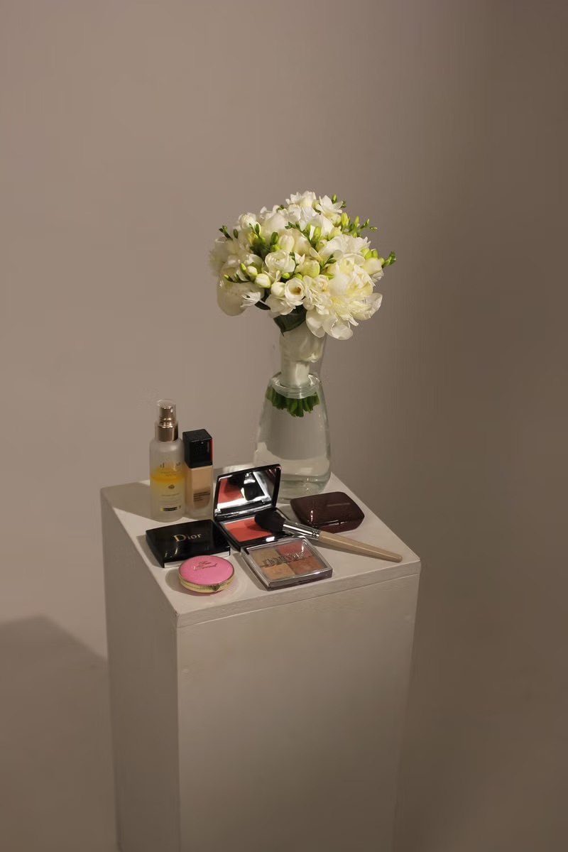 Makeup products staged with flowers for an ecommerce campaign